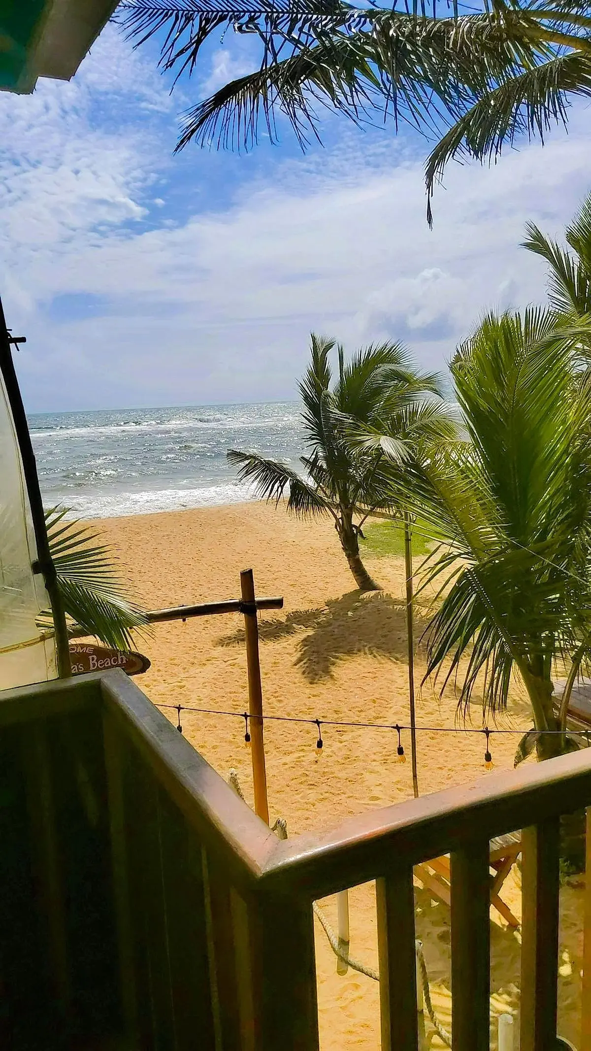 View of the beach and sea from the upstairs timber balcony