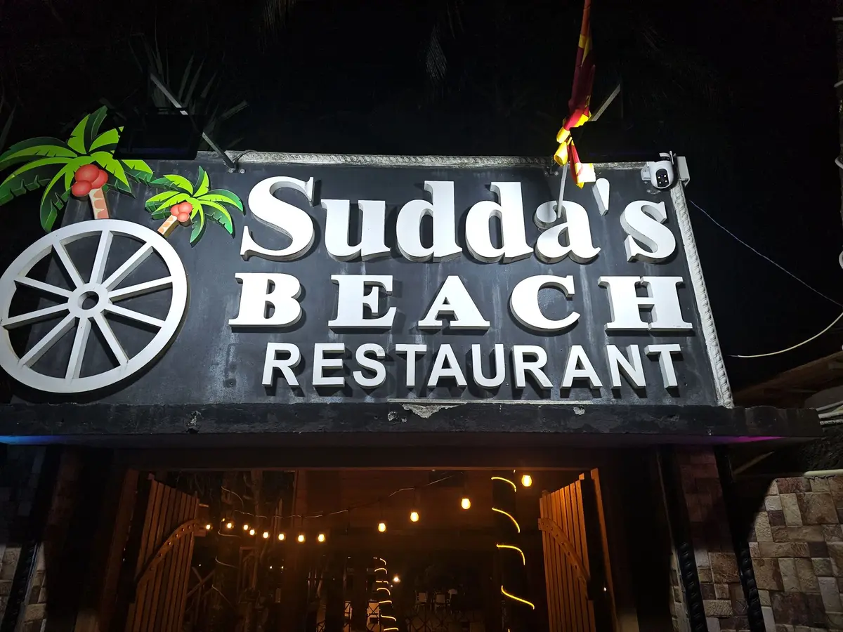 Sudda's Beach Restaurant light-up sign with palm motif